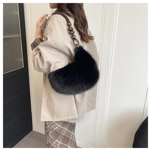Detail of black faux fur crescent bag featuring vintage style wooden beaded handle