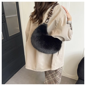 Close-up of black faux fur shoulder bag featuring vintage wooden beaded strap details