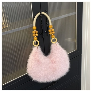Detail of pink faux fur bag featuring wooden beads on a white cord handle
