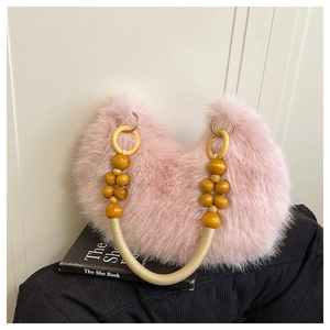 Detailed texture of pink faux fur handbag with beaded wooden handle and braided rope