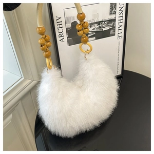 Detail of white faux fur handbag featuring unique wooden beads and woven shoulder strap