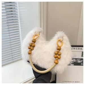 Close-up of fluffy white plush handbag with decorative wooden beads and woven handle