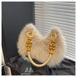 Detail of warm beige faux fur tote bag with yellow wooden beaded handle and woven rope