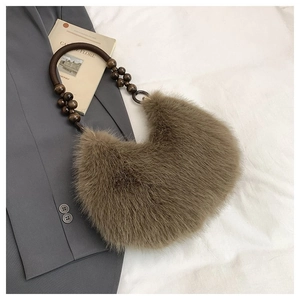 Detail of tan faux fur hobo bag with vintage wooden beads and brown resin handle