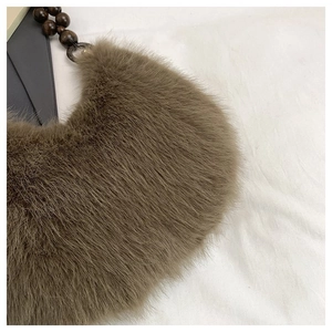 Detail of soft brown faux fur texture and dark brown wooden bead handle on the plush bag