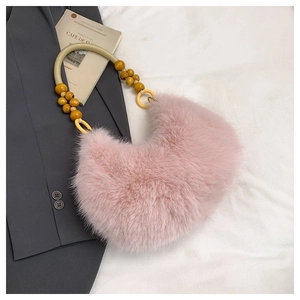 Detail of pink faux fur crescent bag featuring stylish wooden bead handle decoration