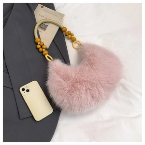 Detailed view of pink faux fur crescent bag with beaded rope handle and soft plush texture