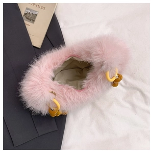 Detailed top view of pink faux fur handbag with zipper closure and beaded ring charms