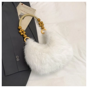 Detail of white faux fur hobo bag with beaded wooden handle and lemon yellow rings