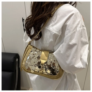 Rear view of model wearing a stylish gold sequin shoulder bag with metallic buckle