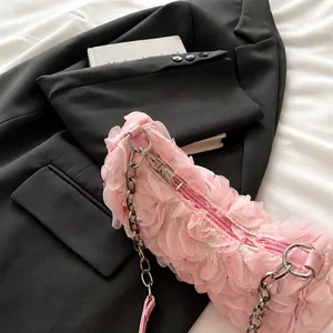 Detail of smooth metal zipper and pink 3D flower texture on the evening clutch bag
