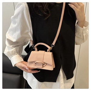 Detail of pink pebbled leather mini crossbody bag with signature ring buckle design