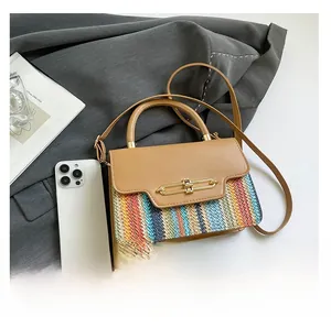 Macro detail of multi-color woven texture and gold metal lock on vintage crossbody bag