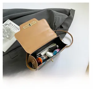 Detail view of brown leather bag interior showing capacity for phone and cosmetics