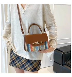 Close-up of contrasting woven texture and golden lock on a chic crossbody flap bag