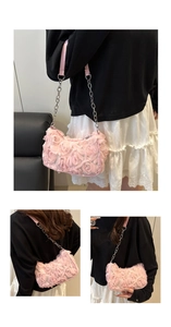 Detailed macro view of 3D pink floral fabric texture and metal chain on underarm bag