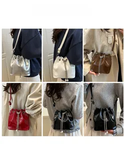 Fashionable drawstring bucket bag in five colors featuring metal chain and pearl charms