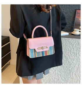 Detail of pink leather and colorful woven texture handbag with golden metal lock