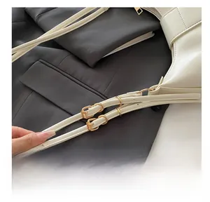 Detail of adjustable white PU shoulder bag strap with elegant gold square buckle