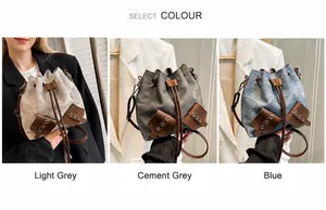 Three bucket bags in light grey, cement grey and blue with drawstring closure and straps