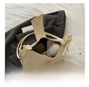 Interior storage view of a minimalist cream shoulder bag showing capacity for daily essentials