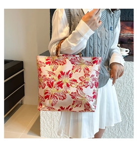 Detail of hand-held floral embroidery tote bag with authentic bamboo handles