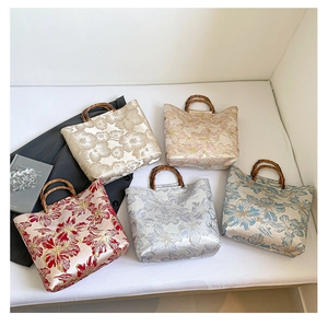 Detailed view of jacquard satin tote bags with vintage floral patterns and bamboo handles