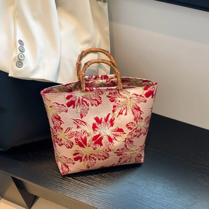 Floral brocade tote bag with natural bamboo handles and 3D embroidery texture