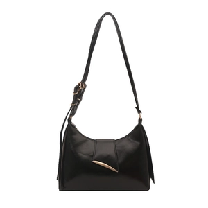 Minimalist black shiny leather shoulder bag with a sleek pointed gold metal buckle