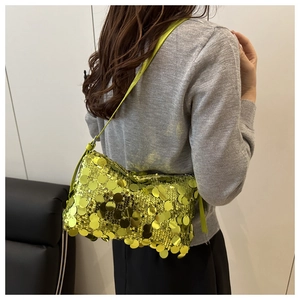 Chic lime green sequin pillow bag shown on shoulder against a minimalist background