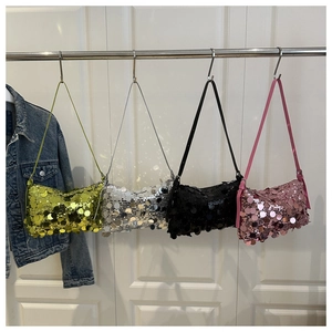 Detail of four colorful sequin shoulder bags in green, silver, black, and pink colors