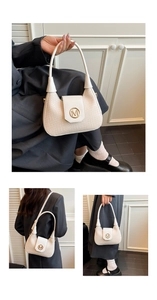 Detail of cream woven shoulder bag featuring a round gold M buckle and leather texture
