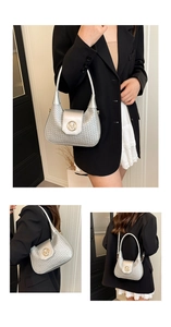 Detail of silver woven texture crescent bag with gold M-logo buckle and shoulder strap