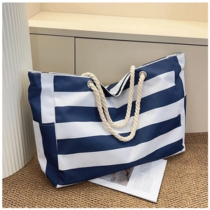 Close-up of blue and white striped canvas tote with decorative thick rope handles