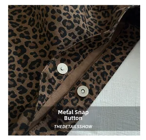 Detail shot of the high-quality magnetic snap closures on the leopard print tote bag