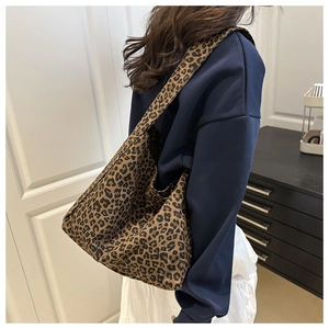Detailed view of the large leopard print canvas tote bag with a wide shoulder strap