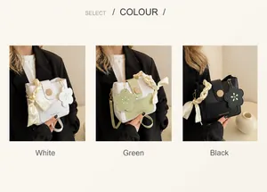 Three elegant leather bucket bags in white, green, and black with floral charms