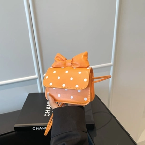 Chic orange polka dot mini crossbody bag with a decorative bow and slim shoulder strap