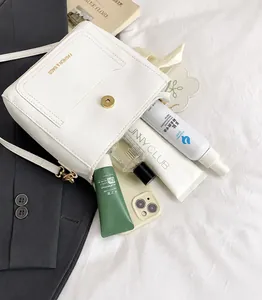 Top view of white leather bucket bag interior showing spacious capacity for cosmetics