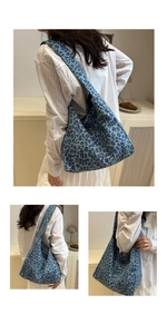 Detail of blue leopard print canvas tote bag with spacious interior and wide shoulder strap