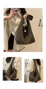 Detailed views of leopard print canvas tote bag showing the wide shoulder straps and texture