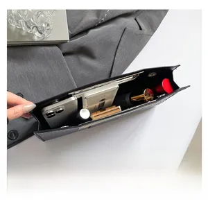 Top view of large capacity black textured clutch bag showing interior storage and essentials