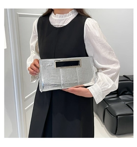 Silver crocodile texture clutch bag featuring a rectangular hollow metal handle design