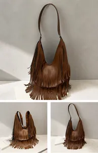 Detail view of coffee brown hobo bag with long fringes and smooth synthetic leather texture