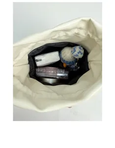 Interior view of the cream leather bucket bag showing spacious storage for daily items