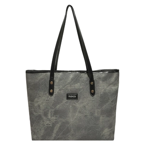Gray canvas tote bag with marble pattern, long black straps and fashion tag on front