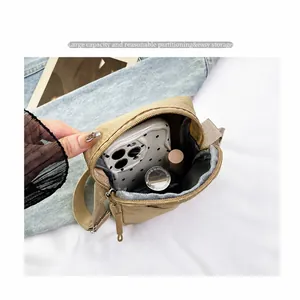 Detailed interior of khaki crossbody phone bag with partitioned compartments for storage