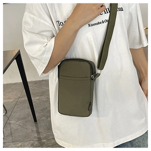 Detail of army green nylon mini crossbody phone bag with metal zipper and adjustable strap