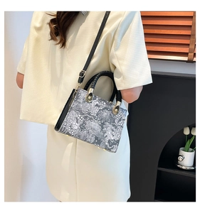 Detail der Vintage-Handtasche mit Umhängeriemen und Retro-Blumenmuster-Drucken