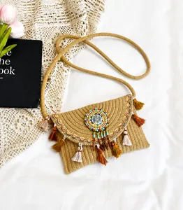 Detail van geweven crossbodytas met kleurrijke kwastjes en mandala-kralenwerk
